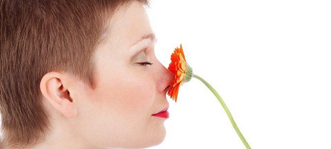 woman smelling a flower