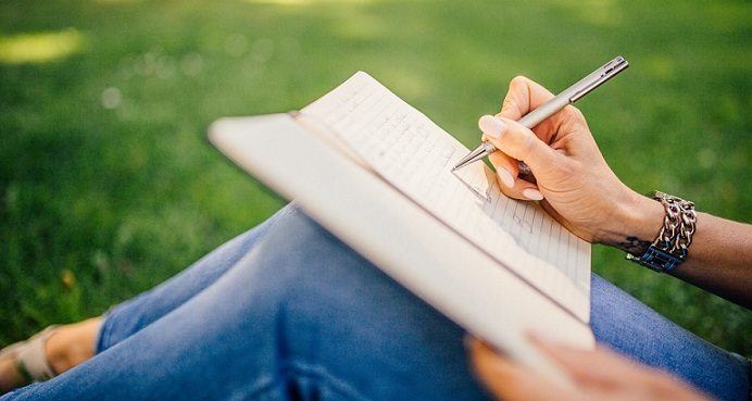 writing content with pen and paper