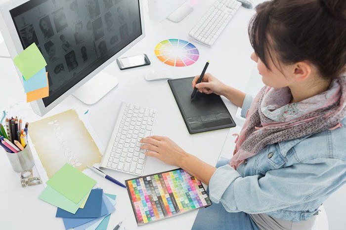 Young woman working at a computer station as an example of jobs for people with ADHD