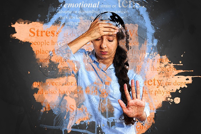 Woman looking stressed out with her hand on her forehead as an example of jobs for people with anxiety