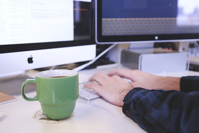 Man working at his computer as an example of jobs for English majors