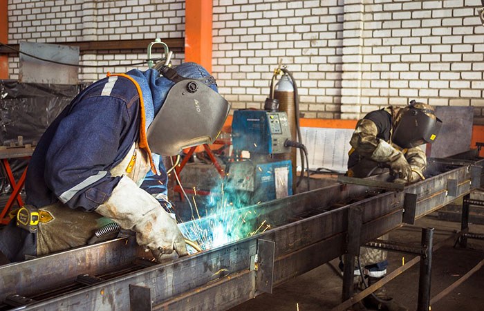 Man working in a shop welding a steal beam as an example of best jobs for welders