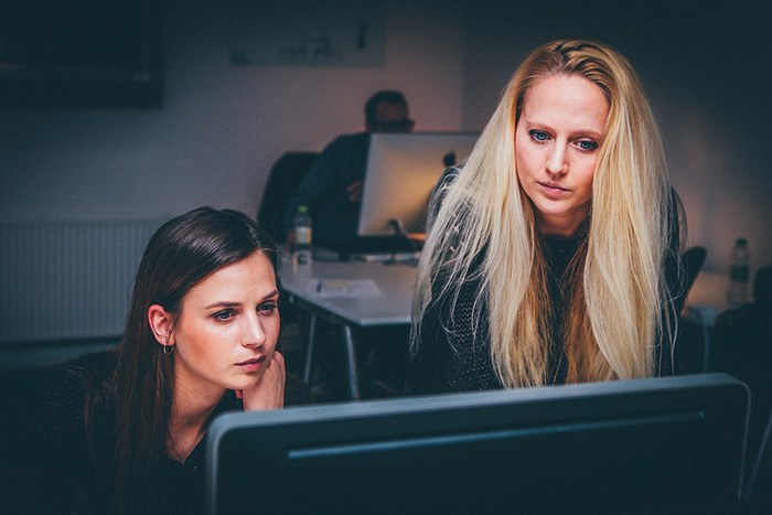 Two women working in an office setting representing jobs for women