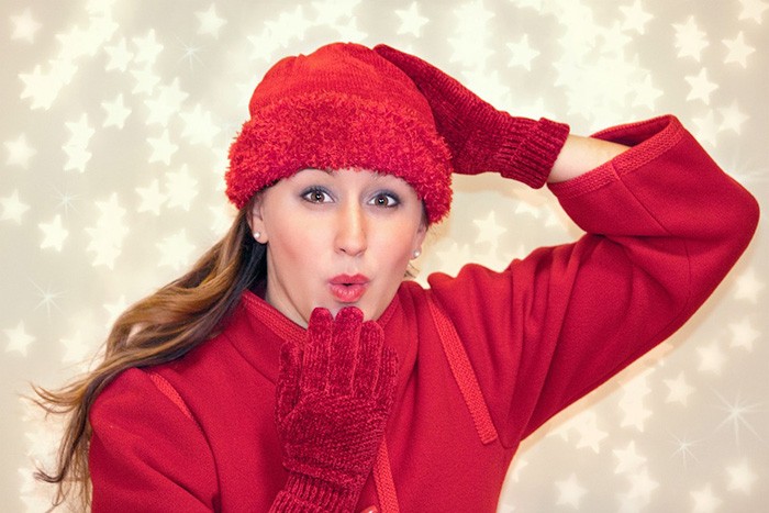 Woman dressed in red Christmas attire representing the best jobs for Christmas