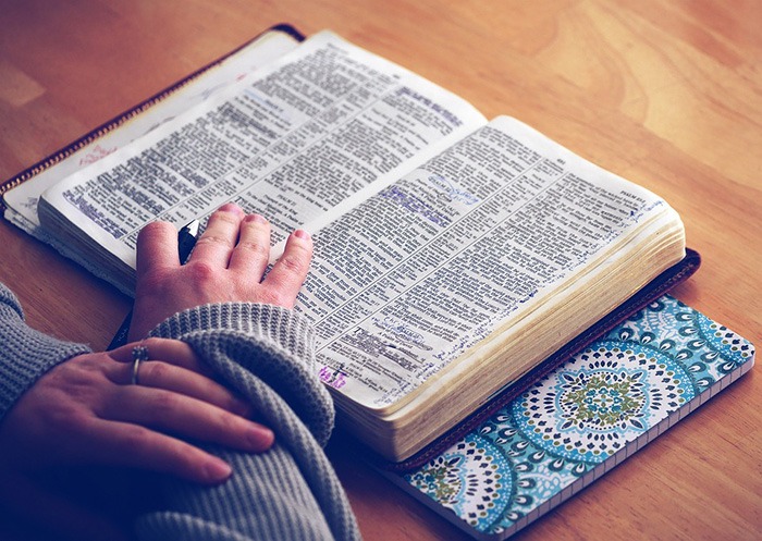 Photo of an open Bible on a desk as an example of Christian freelance writing jobs