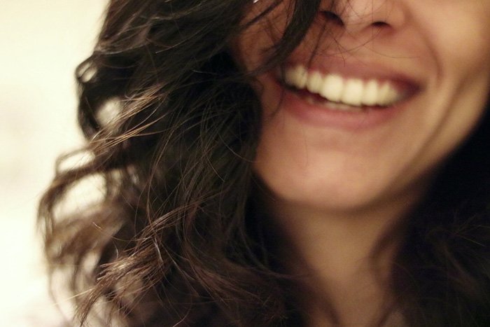 Photo of woman laughing as as an example of writing comedy