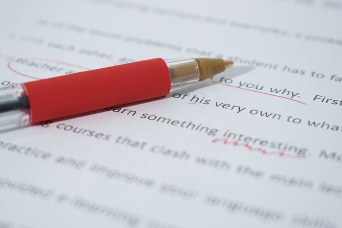 Photo of a pen and paper as an example of an essay