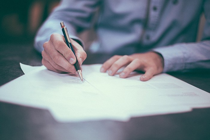 Photo of a man writing a letter as an example of getting paid to write letters