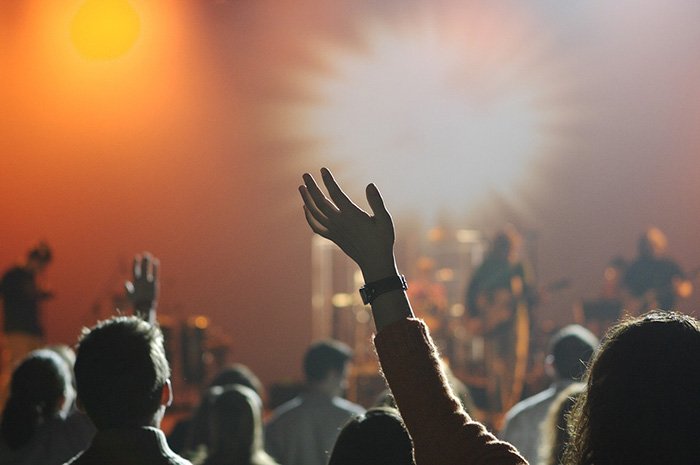 Photo of people attending a rock concert as an example of music reviews