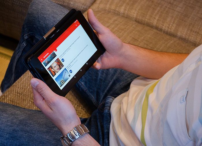 Photo of a man looking at an online magazine