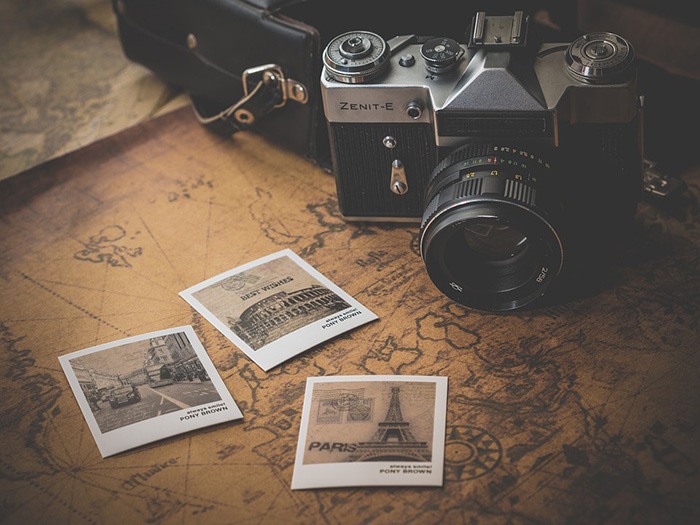 Photo of a camera sitting on a world map as an example of travel reviews