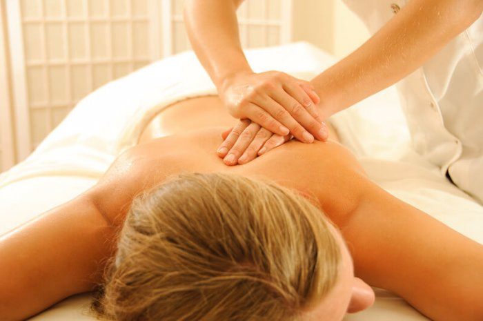 Image of blonde lady receiving a massage from a professional massage therapist