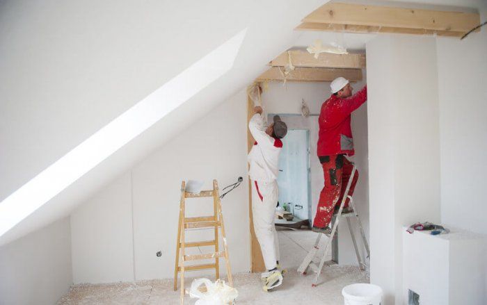 to professional painters painting an attic