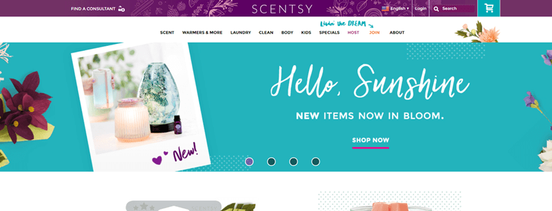 Scentsy website screenshot showing a blue banner with the words ‘Hello, Sunshine’, A diffuser and candle are also highlighted, along with various flowers. 