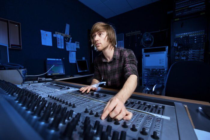 sound technician tweaking a knob and looking intensely