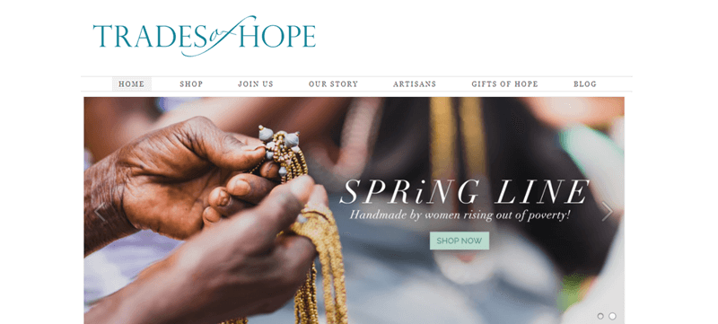 Trades of Hope website showcasing a pair of brown hands working on creating a necklace of some kind. 