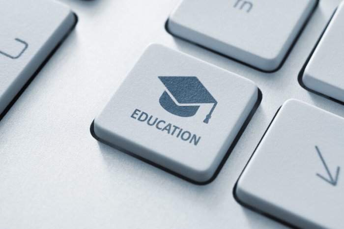 graduation cap on a keyboard button with the word "education" below the cap