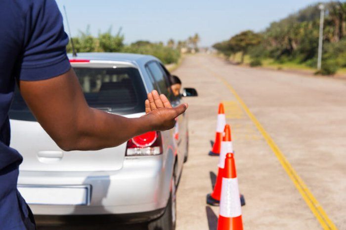image of man's arm giving instructions to a car backing up, representing the best backup plugins wordpress
