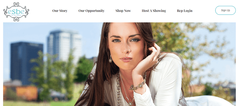 eSBe website screenshot featuring a brown haired woman outside wearing various pieces of jewelry. 