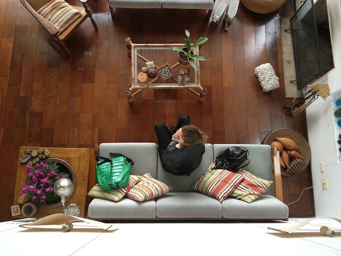woman on a couch house sitting as a side gig