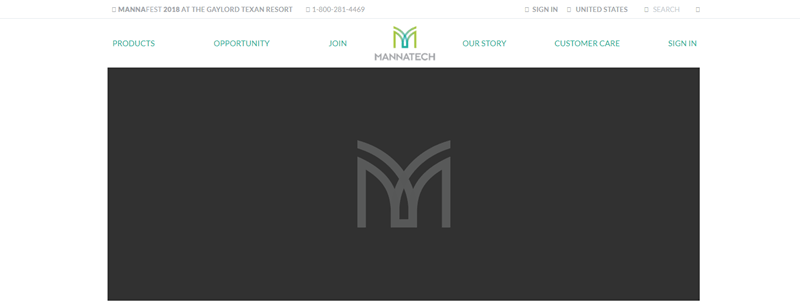 Mannatech website screenshot showing the light gray Mannatech logo against a dark gray background. 