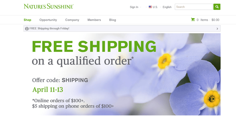 Nature’s Sunshine website screenshot showing a background image of blue flowers and details about shipping. 