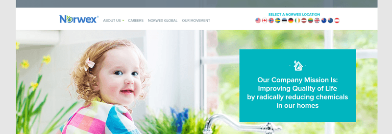 Norwex website screenshot showing a toddler sitting inside with various plants. 