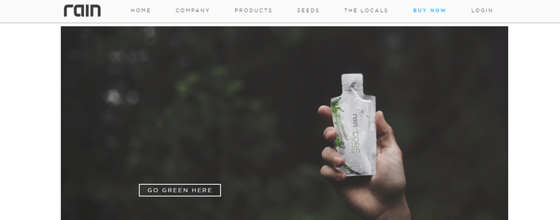 Rain website screenshot showing the blurred background of a forest with a hand holding one of the rain CORE sachets. 