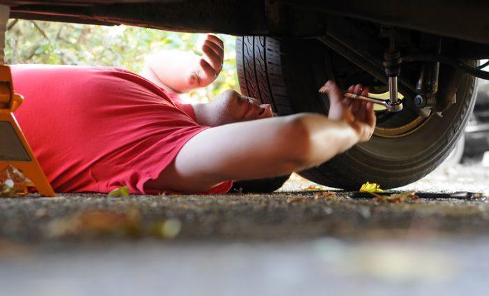 man working on car at his home representing car affiliate programs