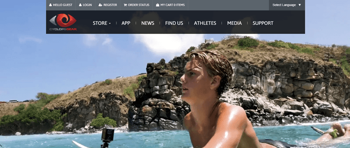 Cyclops Gear website screenshot showing a young man on a surfboard with cliffs and sky in the background. 