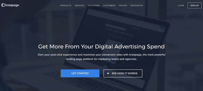 Instapage website screenshot showing a background image of a laptop, overlaid with white text about getting more from digital advertising. 