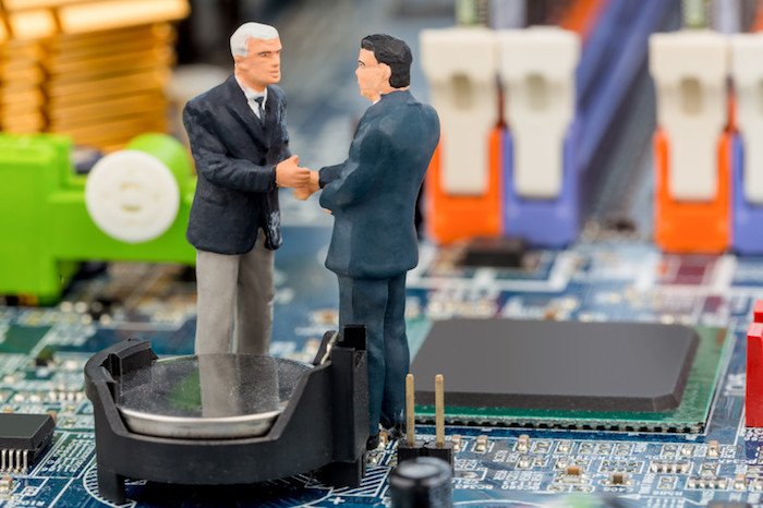 toy men standing on top of computer chip shaking hands showing best b2b affiliate programs