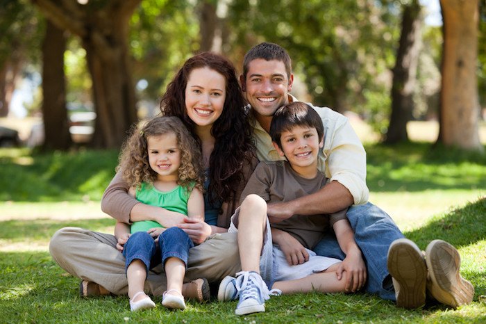 father, mother, and two young children in the park representing the best family affiliate programs