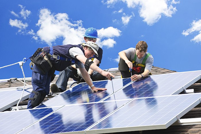 three men installing solar panels on a residential roof representing best solar energy affiliate programs