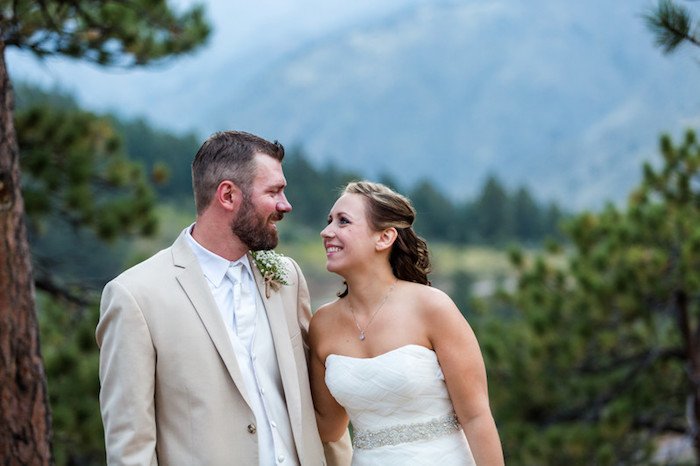 middle aged couple getting married with a forest in the background