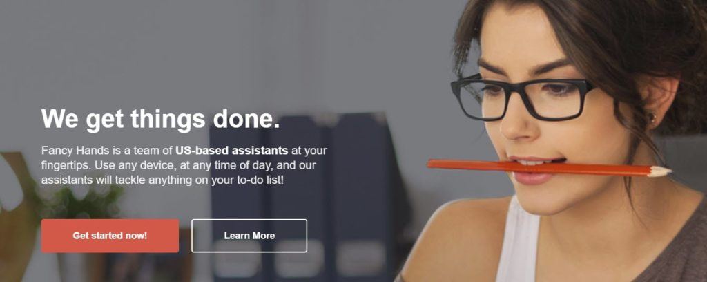 Fancy Hands website screenshot showing a young woman in glasses with a pencil between her teeth. 