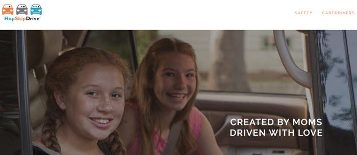 HopSkipDrive website screenshot showing two smiling young girls in the backseat of a car. 