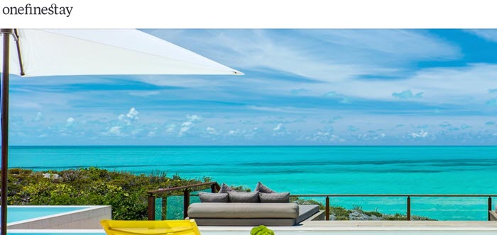 OneFineStay website screenshot showing a beautiful scenic image looking out from a vacation home onto the clear blue ocean. 