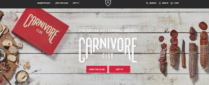 Carnivore Club website screenshot showing a white wooden background, the box and various cured meats. 