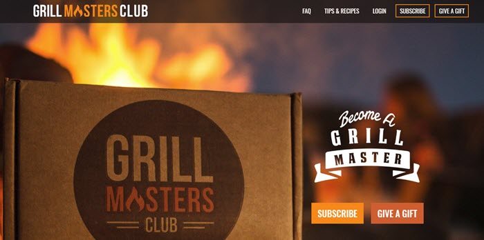 Grill Masters Club website screenshot showing a foreground image of the box with a fire of some type blurred out in the background. 