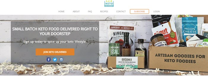 Keto Delivered website screenshot showing the box and selection of snacks on the ground against a white wooden wall. 