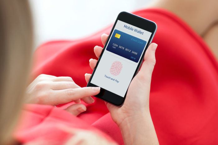 woman in red dress making a smartphone purchase using fingerprint