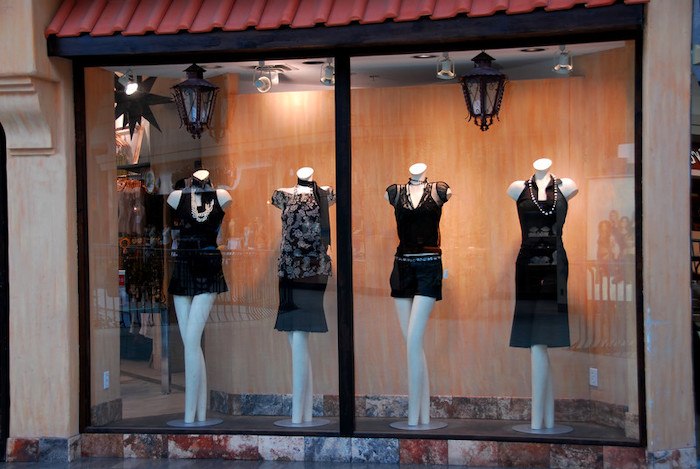 designer clothing sitting on mannequins at a boutique shop