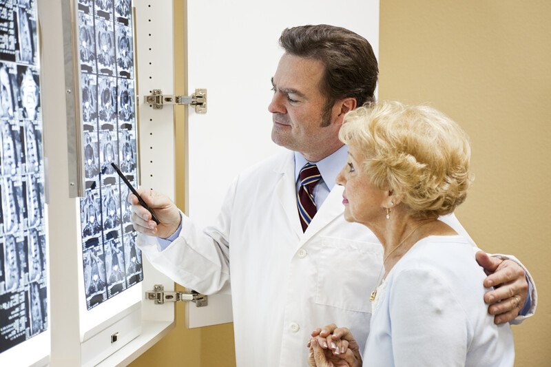 doctor showing his patient a panel of x-rays which represent wealthy affiliate results