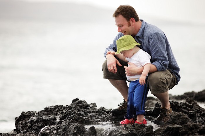 young father and his child standing on beach rocks representing best fathers day affiliate programs