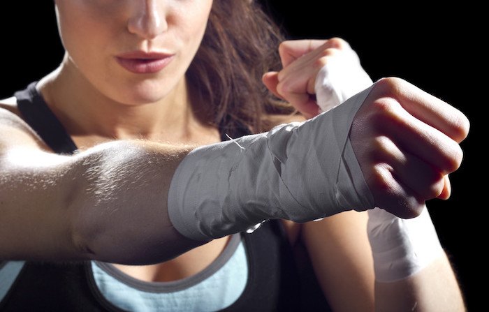 close up photo of a wrapped fist from a woman to represent the best self defense affiliate programs