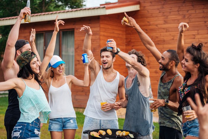 young millenials partying in the back yard with beer and barbecue representing the best summer affiliate programs