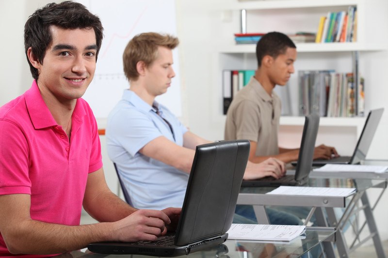 young man creating content on the computer posing for a boring stock photo