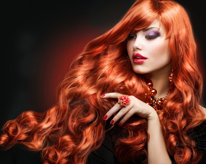 This photo shows a beautiful woman with long red hair, representing the best hair extension affiliate programs.