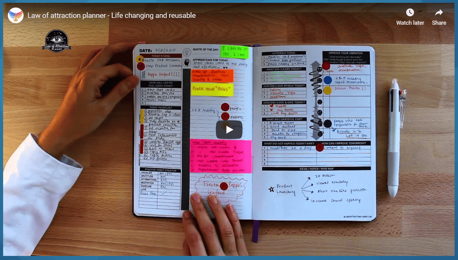 This photo shows a man's hands flipping through a colorful and well-organized Manifestation Planner.